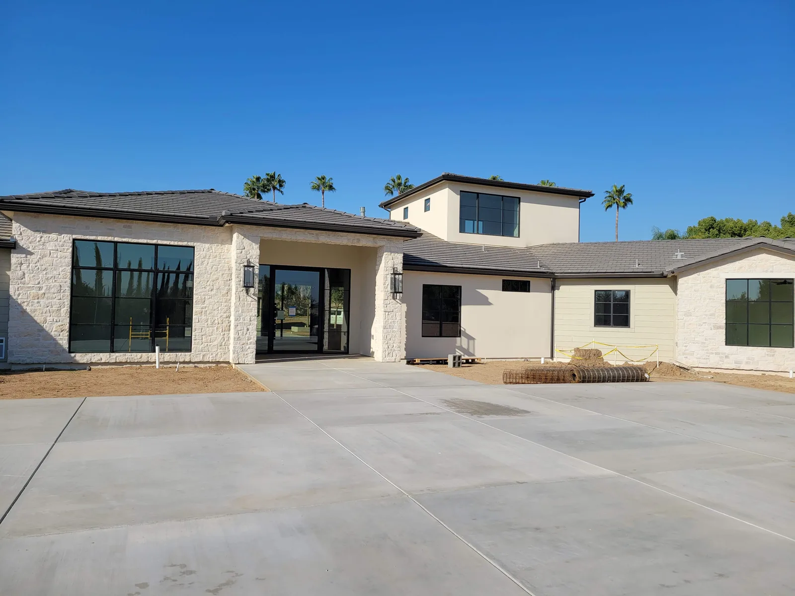 Floor-to-ceiling black-frame Milgard windows